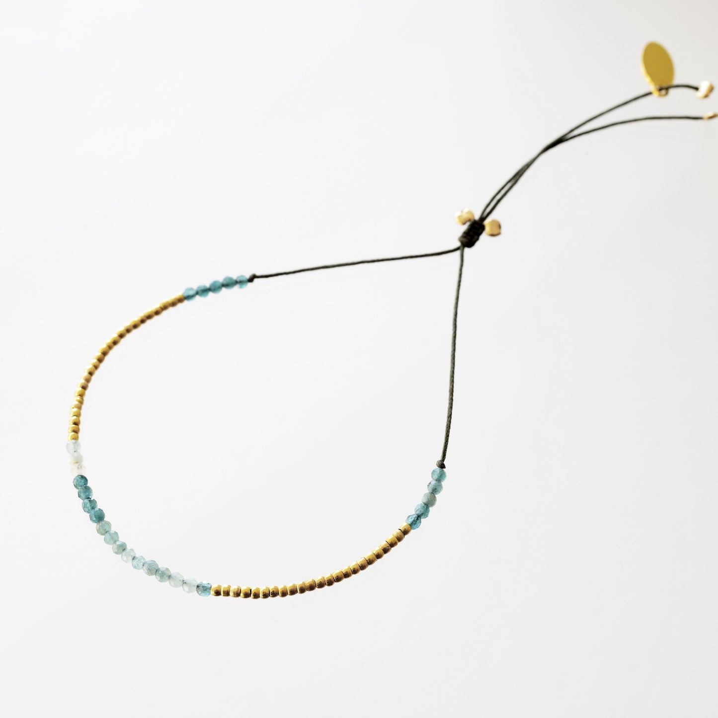 Bracelet on khaki fill with grandidierite and mini pearls